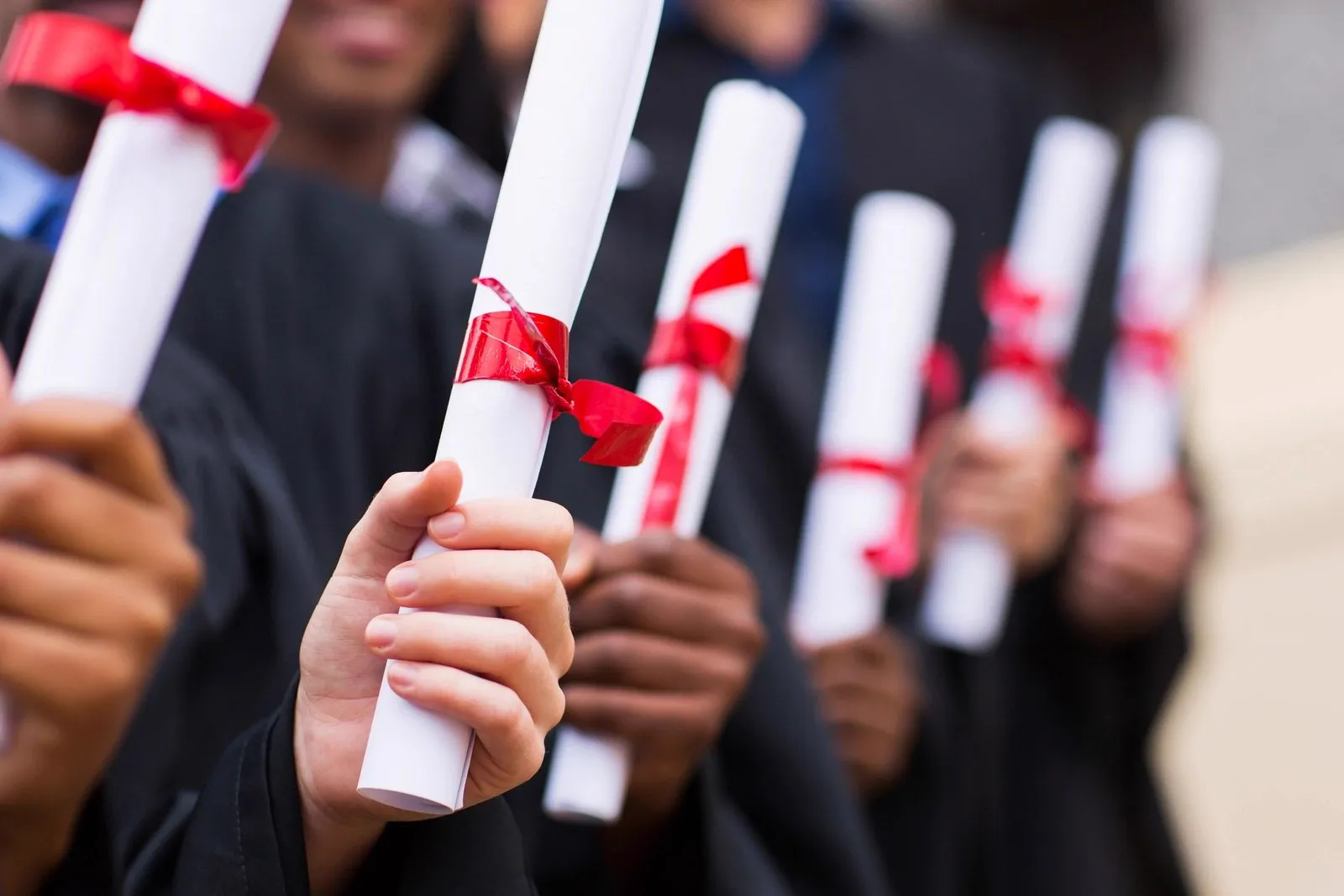 Graduates holding diplomas